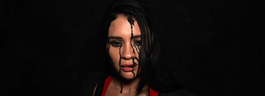 Woman with black liquid running down her face