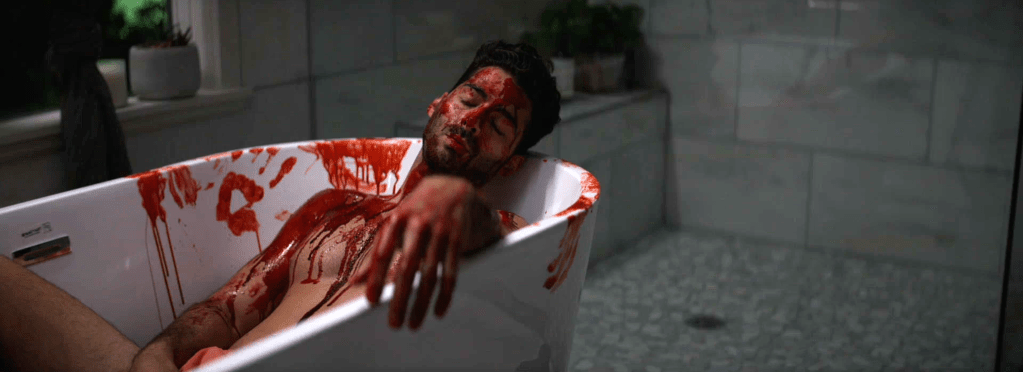 Man in bathtub blood all over him